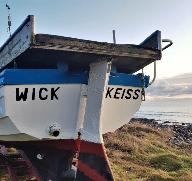 Boat by the sea in fishing village of Keiss in Caithness